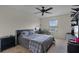 Bedroom features a ceiling fan, closet, and natural light from the window at 750 Maple Leaf Loop, Winter Springs, FL 32708