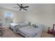 Bedroom featuring two beds, ceiling fan, and natural light from the window at 750 Maple Leaf Loop, Winter Springs, FL 32708