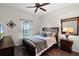 Well-lit bedroom features wood floors, ceiling fan, and a window that allows plenty of natural light to enter the room at 750 Maple Leaf Loop, Winter Springs, FL 32708