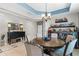 The dining area showcases a blue accent ceiling, a round table and modern decor at 750 Maple Leaf Loop, Winter Springs, FL 32708