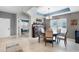 Open dining room features a stylish chandelier, a bar, and large window at 750 Maple Leaf Loop, Winter Springs, FL 32708