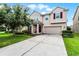 Charming two-story home with a manicured lawn, a two-car garage, and beautiful landscaping at 750 Maple Leaf Loop, Winter Springs, FL 32708