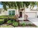 A lovely front entrance with a red door and nicely maintained landscaping at 750 Maple Leaf Loop, Winter Springs, FL 32708