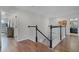 Hallway with hardwood floors and a staircase leading to the lower level of the home at 750 Maple Leaf Loop, Winter Springs, FL 32708