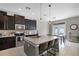 The well-equipped kitchen features a large center island with seating and stainless steel appliances at 750 Maple Leaf Loop, Winter Springs, FL 32708