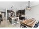 The kitchen showcases an island with seating and a casual dining space with a rustic wooden table at 750 Maple Leaf Loop, Winter Springs, FL 32708