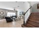 Spacious living room with tiled floor, staircase, ceiling fan, and large window allowing plenty of natural light at 750 Maple Leaf Loop, Winter Springs, FL 32708