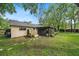 Private backyard featuring a screened-in porch, wooden fence, and a lush lawn, ideal for outdoor enjoyment at 7806 Compass Dr, Orlando, FL 32810