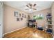 Comfortable home office featuring wood floors, shelves, and natural light at 7806 Compass Dr, Orlando, FL 32810