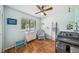 Inviting Bedroom featuring hardwood floors, a charming window view, and cheerful decor at 7806 Compass Dr, Orlando, FL 32810