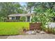 Charming single Gathering home featuring desert landscaping and house number sign, front lawn in view at 7806 Compass Dr, Orlando, FL 32810