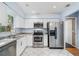 Bright kitchen with white cabinets, stainless steel appliances, and tile flooring at 7806 Compass Dr, Orlando, FL 32810
