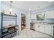 Bright kitchen with stainless steel appliances, granite counters, and white cabinets at 7806 Compass Dr, Orlando, FL 32810