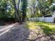 Spacious backyard featuring lush green lawn and mature trees, creating a private outdoor retreat at 830 Moonlit Ln, Casselberry, FL 32707