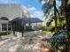 Enclosed patio extending from the home with outdoor living space and landscaped backyard at 830 Moonlit Ln, Casselberry, FL 32707