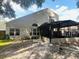 View of the backyard and screened-in lanai, perfect for outdoor entertaining and relaxation at 830 Moonlit Ln, Casselberry, FL 32707