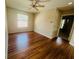 This lovely bedroom features hardwood flooring, a ceiling fan, and a closet at 830 Moonlit Ln, Casselberry, FL 32707