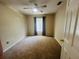 This bedroom features neutral walls, carpet flooring, and a large window with blinds at 830 Moonlit Ln, Casselberry, FL 32707