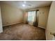 This bedroom features plush carpeting, a window with curtains, and neutral paint at 830 Moonlit Ln, Casselberry, FL 32707
