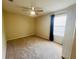 This bedroom is carpeted and features neutral walls, and a ceiling fan at 830 Moonlit Ln, Casselberry, FL 32707