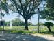 Scenic community area featuring a fountain, white fencing, and mature trees at 830 Moonlit Ln, Casselberry, FL 32707