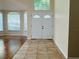 Welcoming foyer with double front doors, tile flooring, and views into the living area at 830 Moonlit Ln, Casselberry, FL 32707