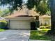 Two-story home featuring an attached two-car garage and a well maintained lawn at 830 Moonlit Ln, Casselberry, FL 32707