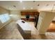 Open-concept kitchen featuring tile floors, wooden cabinets, stainless steel appliances, and a center island at 830 Moonlit Ln, Casselberry, FL 32707
