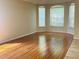 Bright living room boasts hardwood floors, large windows, and a cozy atmosphere at 830 Moonlit Ln, Casselberry, FL 32707