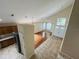 Sun-filled living room area with hardwood floors, a vaulted ceiling, and a view of the front entrance at 830 Moonlit Ln, Casselberry, FL 32707