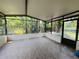 Spacious screened-in patio featuring tile flooring, a white base, and a screened enclosure at 830 Moonlit Ln, Casselberry, FL 32707