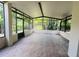 Enclosed outdoor patio with tile flooring, screening, and views of the backyard at 830 Moonlit Ln, Casselberry, FL 32707