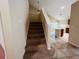 Inviting foyer staircase with plush carpet runner leads to the upper level of this charming home at 830 Moonlit Ln, Casselberry, FL 32707