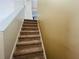 Carpeted staircase leads up to the second floor with neutral walls and white trim at 830 Moonlit Ln, Casselberry, FL 32707
