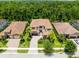 Aerial view of luxury homes, showcasing tile roofs, green lawns, and lush landscaping in a desirable neighborhood at 8480 Adalina Pl, Orlando, FL 32827