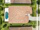An aerial view showcasing a beautiful house with a pristine pool, set in a lush, green neighborhood at 8480 Adalina Pl, Orlando, FL 32827