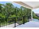 Relax on the balcony with serene views of the lush backyard and pool at 8480 Adalina Pl, Orlando, FL 32827