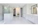 This spacious bathroom features dual sinks, a shower, and a walk-in closet at 8480 Adalina Pl, Orlando, FL 32827