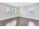 Bedroom features hardwood floors, neutral walls, and large windows that provide plenty of natural light at 8480 Adalina Pl, Orlando, FL 32827