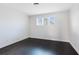 Bedroom features hardwood floors, neutral walls, and large windows that provide plenty of natural light at 8480 Adalina Pl, Orlando, FL 32827