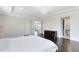 The primary bedroom boasts dark wood floors, tray ceilings, and lots of natural light at 8480 Adalina Pl, Orlando, FL 32827