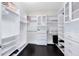 This roomy walk-in closet features custom shelving and storage solutions at 8480 Adalina Pl, Orlando, FL 32827