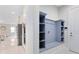 View of the entrance and an entryway storage system, with a refrigerator visible from the kitchen at 8480 Adalina Pl, Orlando, FL 32827
