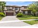 Stunning two-story home with a barrel tile roof, manicured landscaping, and a paver driveway at 8480 Adalina Pl, Orlando, FL 32827
