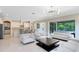 Open-concept living area with a kitchen, fireplace, modern lighting, and access to the backyard patio at 8480 Adalina Pl, Orlando, FL 32827