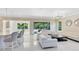 Spacious open-concept kitchen/living area with modern lighting and a seamless transition to outdoor spaces at 8480 Adalina Pl, Orlando, FL 32827