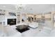 Spacious open-concept living area with modern lighting, fireplace, and a view into the stylish kitchen at 8480 Adalina Pl, Orlando, FL 32827
