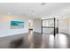 Bright loft area boasts dark wood floors, neutral walls, and an ornate black iron railing at 8480 Adalina Pl, Orlando, FL 32827