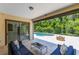 Covered patio with comfortable seating, a fire pit, and a view of the pool and lush backyard at 8480 Adalina Pl, Orlando, FL 32827