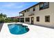 Inviting pool with a unique shape and travertine tile deck, perfect for outdoor entertaining at 8480 Adalina Pl, Orlando, FL 32827